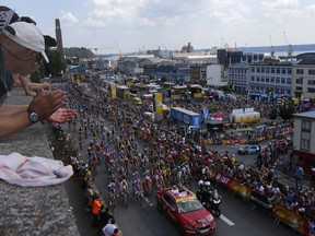 Spectators watch the start of the sixth stage of the Tour de France cycling race over 181 kilometers (112.5 miles) with start in Brest and finish in Mur-de-Bretagne Guerledan, France, Thursday, July 12, 2018.