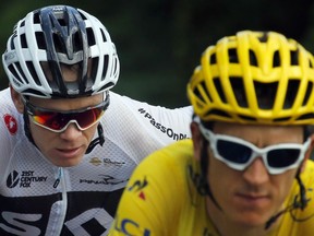 Britain's Geraint Thomas, wearing the overall leader's yellow jersey, and Britain's Chris Froome, ride during the fourteenth stage of the Tour de France cycling race over 188 kilometers (116.8 miles) with start in Saint-Paul Trois-Chateaux and Mende, France, Saturday, July 21, 2018.