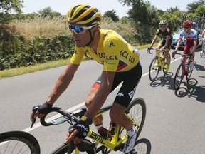 Belgium's Greg van Avermaet, wearing the overall leader's yellow jersey rides in the pack during the fourth stage of the Tour de France cycling race over 195 kilometers (121 miles) with start in La Baule and finish in Sarzeau, France, Tuesday, July 10, 2018.