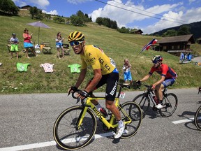 Belgium's Greg van Avermaet, wearing the overall leader's yellow jersey, is followed by Spain's Jon Izaguirre Insausti as they clim Col de la Croix Fry pass during the tenth stage of the Tour de France cycling race over 158.8 kilometers (98.7 miles) with start in Annecy and finish in Le Grand-Bornand, France, Tuesday, July 17, 2018.