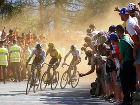 Colombia's Egan Arley Bernal Gomez, Britain's Geraint Thomas, wearing the overall leader's yellow jersey, and Britain's Chris Froome climb alpe d'huez during the twelfth stage of the Tour de France cycling race over 175.5 kilometers (109 miles) with start in Bourg-Saint-Maurice Les Arcs and Alpe d'Huez, France, Thursday, July 19, 2018.