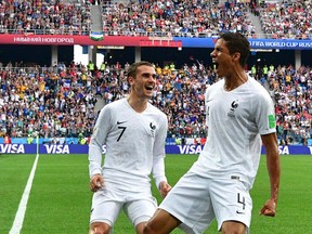 France defender Raphael Varane (right) celebrates his goal against Uruguay with forward Antoine Griezmann at the World Cup on July 6.