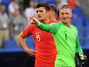 England goalkeeper Jordan Pickford (right) and defender Harry Maguire celebrate their win over Sweden at the World Cup on July 7.