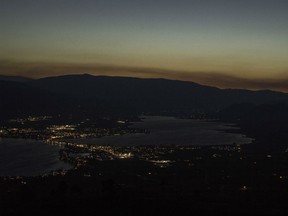 Looking high above the small town of Osoyoos B.C. in the southern Okanagan the glow of smoke and fire illuminates the night sky on Thursday July 19, 2018. Smoke is blanketing B.C.'s Okanagan Valley as several fires continue to burn out of control in the region, jamming traffic on the main highway. The Mount Eneas fire, which is burning between Peachland and Summerland, nearly doubled in overnight and now covers 500 hectares.