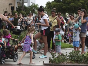 Parents and kids wait in line for close to an hour at Coral Square mall in Coral Springs, Fla., for the Build-A-Bear Workshop Pay Your Age day event, Thursday, July 12, 2018. Customers were allowed customers to purchase a bear and pay their current age with a cap at $29, which was also available at its United Kingdom stores. The chain known for its customizable teddy bears and other stuffed toys couldn't handle the crowds Thursday and had to turn shoppers away.