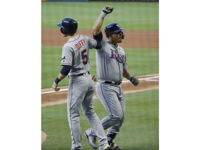 Tampa Bay Rays' Wilson Ramos, right, is congratulated by Matt Duffy (5) after Ramos hit a home run that scored Duffy during the first inning of a baseball game against the Miami Marlins, Tuesday, July 3, 2018, in Miami.