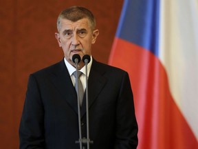 FILE- In this June 6, 2018 file photo newly appointed Prime Minister Andrej Babis addresses the media at the Prague Castle in Prague, Czech Republic. Babis has signed a deal the far-left Communist Party in a move that will give the maverick Communists a role in governing for the first time since the country's 1989 anti-communist Velvet Revolution.