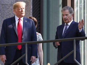U.S. President Donald Trump, left, and Finnish President Sauli Niinisto talk on the balcony of Niinisto's official residence in Helsinki, Finland, Monday, July 16, 2018 prior to his meeting with Russian President Vladimir Putin in the Finnish capital.