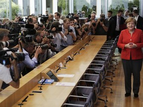 German Chancellor Angela Merkel poses for photographers when arriving for her annual summer press conference at the Bundespressekonferenz in Berlin, Germany, Friday, July 20, 2018.