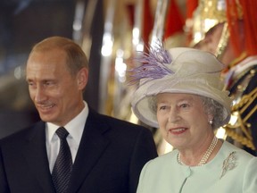 FILE - In this June 24, 2003 file photo Russian President, Vladimir Putin, stands by Britain's Queen Elizabeth II before they enter Buckingham Palace, London.