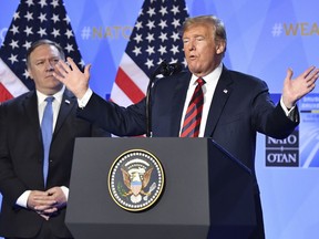 U.S. President Donald Trump raises his hands during a press conference after a summit of heads of state and government at NATO headquarters in Brussels, Belgium, Thursday, July 12, 2018. NATO leaders gather in Brussels for a two-day summit.