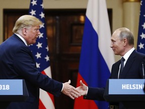 U.S. President Donald Trump shakes hands with Russian President Vladimir Putin at the end of the press conference after their meeting at the Presidential Palace in Helsinki, Finland, Monday, July 16, 2018.