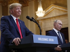 U.S. President Donald Trump, left, smiles beside Russian President Vladimir Putin during a press conference after their meeting at the Presidential Palace in Helsinki, Finland, Monday, July 16, 2018.