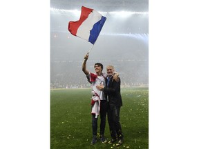 France head coach Didier Deschamps, right, celebrate with his son Dylan after France won 4-2 during the final match between France and Croatia at the 2018 soccer World Cup in the Luzhniki Stadium in Moscow, Russia, Sunday, July 15, 2018.