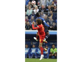 Belgium's Marouane Fellaini and France's Samuel Umtiti, top, vie for the ball during the semifinal match between France and Belgium at the 2018 soccer World Cup in the St. Petersburg Stadium, in St. Petersburg, Russia, Tuesday, July 10, 2018.