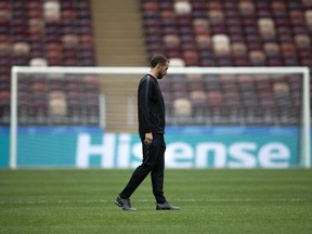 England head coach Gareth Southgate walks along the pitch after England's official news conference on the eve of the semifinal match between England and Croatia at the 2018 soccer World Cup in the Luzhniki stadium in Moscow, Russia, Tuesday, July 10, 2018.