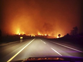 In this photo released Friday, July 6, 2018, by the California Highway Patrol, the Klamathon Fire burns in Hornbrook, Calif. A local California official says a deadly blaze burning near the Oregon border moved swiftly through the rural area that is home to many retirees. Siskiyou County Board of Supervisors chair Ray Haupt says the blaze moved so fast it quickly reached Hornbrook, a community of about 250 people about 14 miles (22 kilometers) south of the Oregon border. Authorities said one person was killed in the fire. (California Highway Patrol via AP)