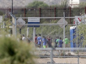FILE - In this June 21, 2018 file photo, detainees are seen inside a facility, where tent shelters are being used to house separated family members at the Port of Entry in Fabens, Texas. The separation of families at the U.S.-Mexico border caught the attention of the world and prompted mass outrage, but it only tells a small part of the story surrounding the Trump administration's immigration policy.
