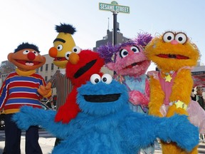 FILE - In this Feb. 10, 2010, file photo, characters from Sesame Street Live appear on the street by Madison Square Garden to celebrate the 30th anniversary of the live touring stage shows based on the PBS television series. in New York. From left are Ernie, Bert, Elmo, Cookie Monster (foreground), Abby Cadabby, and Zoe. The Sesame Street company is taking its beloved, critically-acclaimed brand of educational television into the highly profitable world of classroom curriculum. It's a move that experts say could open the door for other companies to sink their teeth into a sacred learning space. Sesame Workshop and McGraw-Hill Education announced their new partnership Thursday, July 19, 2018.