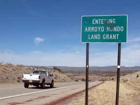 FILE - In this March 26, 2013 file photo, the sign of the Arroyo Hondo Land Grant is shown at the entrance of the historical northern New Mexico Spanish land grant. Republican Congressman Steve Pearce of New Mexico has introduced a bill aimed at giving Hispanic families stronger measures to review claims of lost lands under the 1848 Treaty of Guadalupe Hidalgo, the treaty that ended the U.S.-Mexican War. Meanwhile, New Mexico Attorney General Hector Balderas announced this week he is seeking to void a 2003 land transfer from a historic Hispanic land grant in New Mexico to a Colorado group on grounds it was illegal.