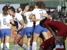 France's Shannon Izar, second from left, and teammates celebrate as Canada players react to a France score during the Women's Rugby Sevens World Cup in San Francisco, Friday, July 20, 2018.