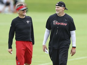 FILE - In this June 14, 2018, file photo, Atlanta Falcons general manager Thomas Dimitroff, left, and head coach Dan Quinn share a laugh during an NFL football minicamp in Flowery Branch, Ga. Falcons general manager Thomas Dimitroff and coach Dan Quinn, who have led the team to the playoffs the last two seasons, have signed three-year contract extensions. The deals were announced Wednesday, July 25, 2018, a day before players report for training camp.