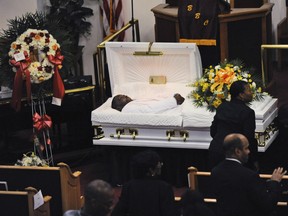 Eric Garner's body lies in a casket during his funeral at Bethel Baptist Church in the Brooklyn borough of New York. The 43-year-old black man died in July 2014 in New York City after a white officer placed him in a chokehold during an arrest for selling loose cigarettes. A grand jury declined to indict that officer, nor any others involved in the arrest. The city agreed to pay a $6 million civil settlement.