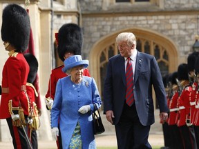 President Donald Trump with Queen Elizabeth II, inspecting the Guard of Honour at Windsor Castle in Windsor, England, Friday, July 13, 2018.