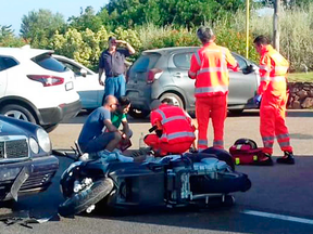 Ambulance personnel tend to George Clooney after the actor was involved in a scooter accident on the Sardinia island in Italy, July 10, 2018.