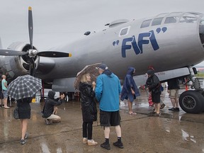 People take a look at the outside of FIFI, a Boeing B-29 Superfortress at Saint-Hubert airport south of Montreal, Sunday, July 22, 2018.THE CANADIAN PRESS/Graham Hughes