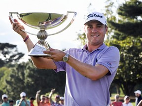 In this Sept. 24, 2017 file photo, Justin Thomas holds the FedEx Cup trophy in Atlanta.