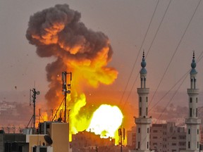A picture taken on July 20, 2018 shows a fireball exploding in Gaza City during Israeli bombardment. Israeli aircraft and tanks hit targets across the Gaza Strip on July 20 after shots were fired at troops on the border, the army said, with Hamas reporting several members of its military wing killed in the latest flare-up in months of tensions.