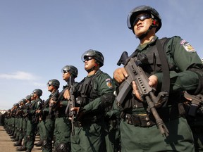 Cambodian riot police officers stand in lines before being sent to polling stations for securities in Phnom Penh, Cambodia, Wednesday, July 25, 2018. Cambodia's general elections were scheduled for July 29.