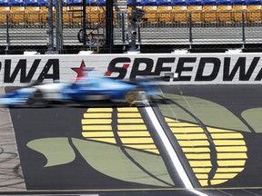 Ed Jones (10) passes the finish line during practice for the IndyCar Series auto race, Saturday, July 7, 2018, at Iowa Speedway in Newton, Iowa.