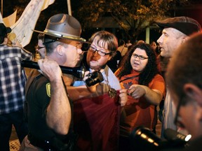 In an Oct. 10, 2011 photo, Lt. Mark Logsdon tells Occupy Des Moines demonstrators it's time to leave state property after 11p.m. Monday night. A woman who reported being sexually harassed by a trooper says Iowa State Patrol Capt. Mark Logsdon failed to act on her complaint.