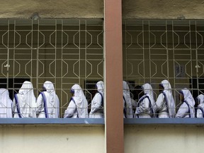 FILE- In this April 27, 2011 file photo, nuns of Missionaries of Charity, the order founded by Mother Teresa, stand in a queue to cast their vote during West Bengal state assembly elections in Kolkata, India. Police in eastern India say they have arrested a nun and another worker at a shelter run by Mother Teresa's charity for allegedly selling a baby.