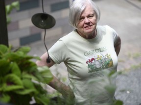 Anne Hunt stands in her garden at her home in Chicago on Friday, July 13, 2018. Since Hunt's Alzheimer's diagnosis in 2016, she has started gardening as a form of therapy.