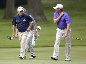 Jeff Sluman, left, and Lee Janzen chat as they come up to the eighth green during the first round of the Constellation Senior Players Championship golf tournament at Exmoor Country Club in Highland Park, Ill., Thursday, July 12, 2018.