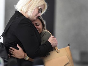 Sirley Silveira Paixao, right, an immigrant from Brazil seeking asylum, hugs her Chicago based attorney Britt Miller, after a hearing where a federal judge ordered the release of her 10-year-old son Diego from immigration detention, Thursday, July 5, 2018, in Chicago. Silveira Paixao arrived in this country with her son on May 22 and was separated from him shortly after.