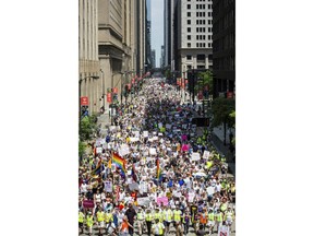 People participate in the Families Belong Together march in Chicago on Saturday, June 30, 2018. In major cities and tiny towns, marchers gathered across America, moved by accounts of children separated from their parents at the U.S.-Mexico border, in the latest act of mass resistance against President Donald Trump's immigration policies.