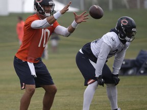 Chicago Bears quarterback Mitchell Trubisky, left, catches a ball as running back Jordan Howard looks to the field during an NFL football training camp in Bourbonnais, Ill., Saturday, July 21, 2018.