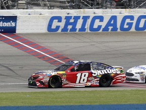 Kyle Busch crosses the finish line to win a NASCAR Cup Series auto race at Chicagoland Speedway in Joliet, Ill., Sunday, July 1, 2018.