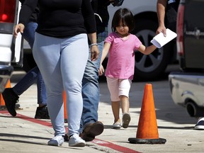 Immigrant families leave a United States Immigration and Customs Enforcement facility after they were reunited, Wednesday, July 11, 2018, in San Antonio.