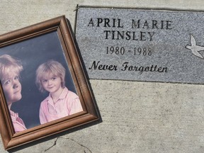 FILE - In this March 30, 2018, file photo, a photo of April Tinsley was placed in the garden that was dedicated in her honor near where she disappeared in Fort Wayne, Ind. April 1 marked the 30th anniversary of her death. Police on Sunday, July 15, 2018, arrested John Miller, of Grabill, Ind., in connection to her death. Authorities say Miller agreed to speak with police in Fort Wayne and made incriminating statements about abducting, assaulting and killing Tinsley. An affidavit released by the Allen County prosecutor says investigators have DNA evidence linking Miller to the girl.