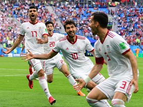 Iranian forward Mehdi Taremi, left, forward Sardar Azmoun, forward Karim Ansari Fard and midfielder Ehsan Haji Safi react after Morocco scored an own goal during the Russia 2018 World Cup at the Saint Petersburg Stadium on June 15, 2018.