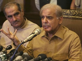 Shahbaz Sharif, brother of Pakistan's former Prime Minister Nawaz Sharif, who now heads the Pakistan Muslim League, addresses a news conference in Lahore, Pakistan, Thursday, July 12, 2018. Shahbaz Sharif condemned the arrests of their supporters, demanded they stop and that everyone detained be immediately released. He told reporters in Lahore that he plans to be at "the rally tomorrow to welcome Nawaz Sharif who is returning home with his daughter."