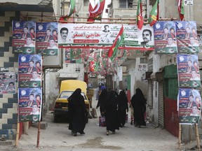 Streets are decorated with posters of election candidates in Karachi, Pakistan, Tuesday, July 10, 2018. Pakistan's military announced on Tuesday that it would deploy more than 371,000 members of the country's security forces to polling stations to ensure free, fair and transparent national elections on July 25.