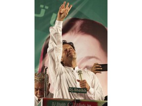 Pakistani politician Imran Khan, chief of Pakistan Tehreek-e-Insaf party, waves to his supporters during an election campaign in Lahore, Pakistan, Monday, July 23, 2018. Pakistan will hold general elections on July 25.