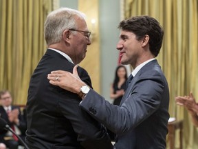 Bill Blair is congratulated by Prime Minister Justin Trudeau after being sworn in as Minister of Border Security and Organized Crime Reduction during a ceremony at Rideau Hall in Ottawa on Wednesday, July 18, 2018.