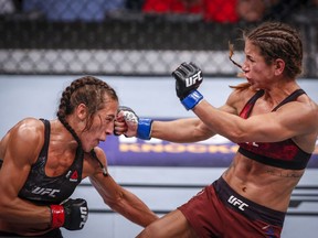 UFC women's strawweight fighter Joanna Jedrzejczyk, left, and UFC women's strawweight fighter Tecia Torres fight during UFC Fight Night in Calgary, Alta., Saturday, July 28, 2018.THE CANADIAN PRESS/Jeff McIntosh
